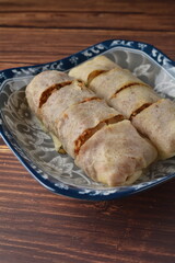 Homemade traditional asian food nyonya Popiah Spring Roll fresh vegetables, bean curd, fried shallots, dried shrimp, sweet chili paste and braised turnip on wood table vegan halal menu for cafe