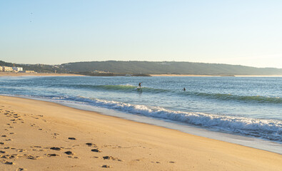 Surfers school on Nazare Beach at sunny day. Portugal