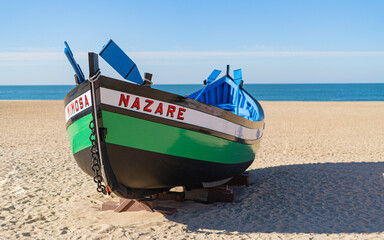 Traditional wooden boat on the beach at Nazare, Portugal.