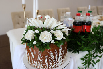 Wedding loaf with edible swans. National wedding traditions.
