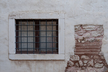 old window on the facade of an old wall