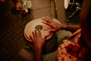 High angle view of unrecognizable man playing conga in Afro-Cuban jazz band