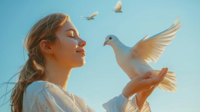 A woman holding a white dove about to release it into the sky, plain clear blue sky background, symbolic of letting go and forgiving