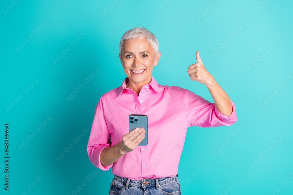 Sticker portrait of pretty aged lady smart phone thumb up wear pink shirt isolated on turquoise color backgr