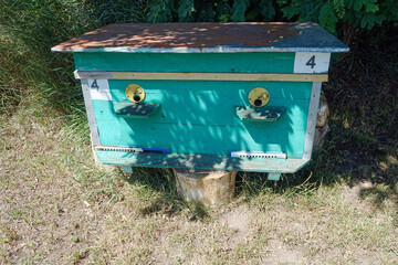 A wooden beehive for bees in a clearing   
