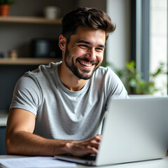 Young man using laptop and smiling