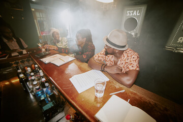 High angle view of modern African American jazz band working on new album or repertoire while...