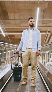 Man with basket on the escalator at the materials market building