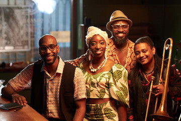 Cheerful African American jazz music band members posing together for camera, medium portrait