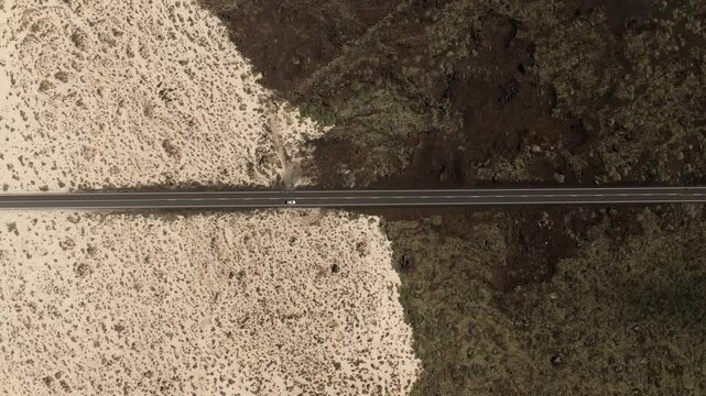 Aerial view of a beautiful desert landscape with a winding road and rocky terrain, Caleta del Mojon, Lanzarote, Canary Islands, Spain.