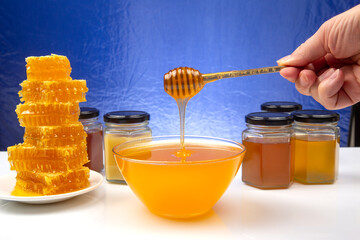 Fresh flower honey in a wooden bowl, spoon and honeycomb. vitamin food for health and life