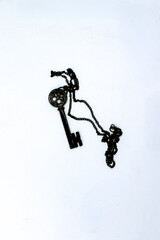 Black key necklace on isolated white background.