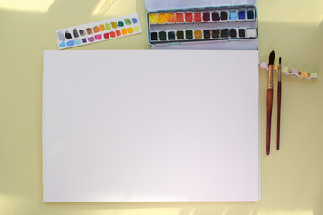 mock-up white paper blank watercolour painting with brushes and paints