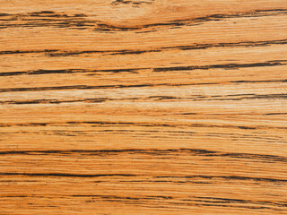 Close-up of a wooden surface with distinct texture. Natural patterns and warm wood tones create an attractive backdrop for a variety of design