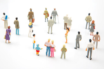 miniature people. different people stand on a white background. communication of society of different generations