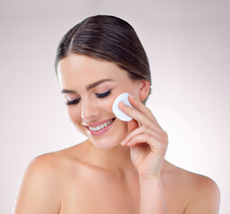 Woman. grooming and cotton pads in studio, toner and remove makeup on background. Female person,...