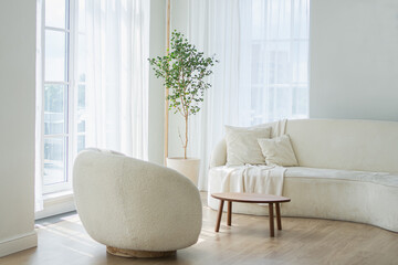 Stylish loft bedroom interior. Spacious design apartment with light walls large windows white couch sofa and armchair. Clean modern decoration with elegant furniture in minimalist Scandinavian style