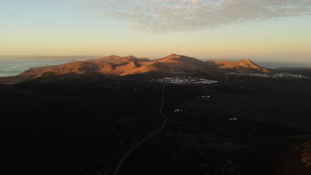 Aerial view of volcanic vines in a serene landscape at sunset, La Geria, Lanzarote, Spain.