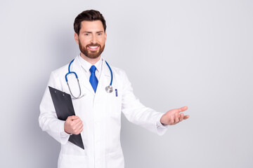 Portrait of experienced doctor man clipboard welcome you wear white coat isolated on grey color background