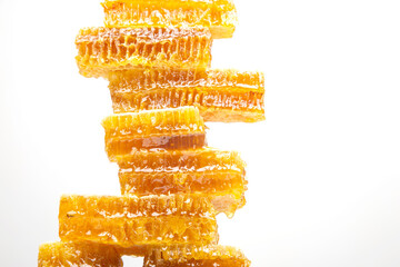 portions of fresh honeycomb on a white background. vitamin natural food. bee work product