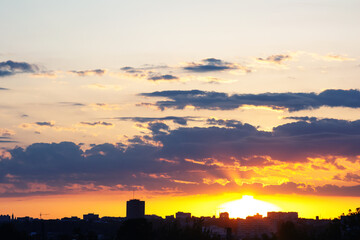 majestic sky after sunset, featuring a gradient from warm red to cool indigo, with scattered clouds...