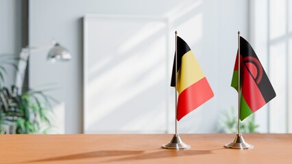 FLAGS OF BELGIUM AND MALAWI ON TABLE