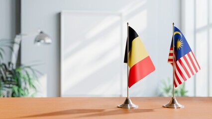 FLAGS OF BELGIUM AND MALAYSIA ON TABLE