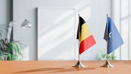 FLAGS OF BELGIUM AND SOMALIA ON TABLE