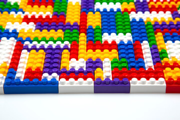 Obraz premium Abstract background texture of colored constructor blocks. Background of colorful plastic part of constructor. Pile of colored toy bricks.
