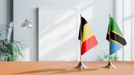 FLAGS OF BELGIUM AND TANZANIA ON TABLE