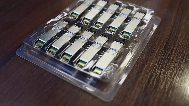 Network engineer arranging optical transceiver modules