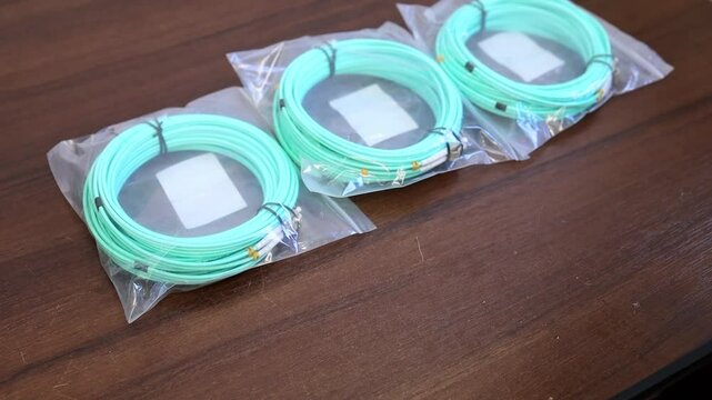 A man lays out a patch cord on the table