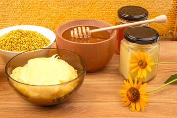 Fresh flower honey in a wooden bowl, spoon and honeycomb. vitamin food for health and life