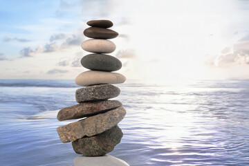 pyramid of stacked stones on the seashore. stabilization and balance in life