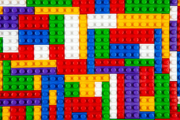 Abstract background texture of colored constructor blocks. Background of colorful plastic part of...