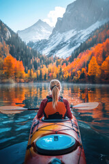 A person kayaking in water with colorful Autumn foliage woods