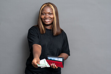 NIgerian woman giving some cash from her purse