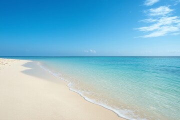 A tranquil beach with clear blue water and soft sand under a bright sunny sky, perfect for a relaxing getaway.