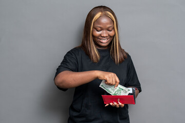NIgerian woman holding some cash from her purse