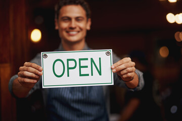 Doorway, portrait and man with open sign for cafe, invite clients and coffee shop hours for...