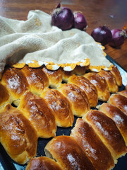 Close-up of baked cabbage pies on a homespun cloth on a wooden table. Concept of traditional Ukrainian, Slavic food