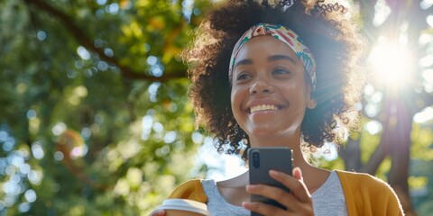 Happy woman enjoying coffee outdoors while discussing career opportunities and networking ideas, using her smartphone for business and social media