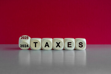 2025 taxes new year symbol. Turned a wooden cube and changes words Taxes 2024 to Taxes 2025....