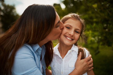 Kiss, mom and happy girl in park for portrait, love or bonding together with single parent, hug or...