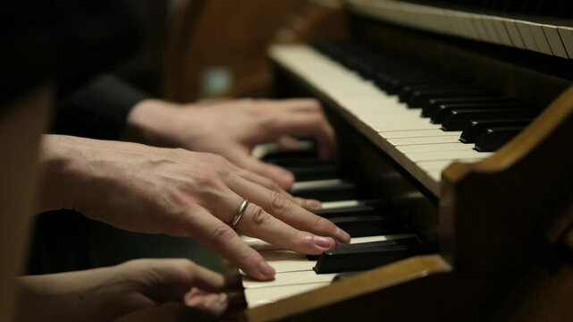 Cinematic, hands an organists , musical performance, antique organ. classical music benches in the cathedral, interior. Classic Catholic Church, close up detail