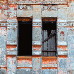 A pair of windows in an old abandoned house before restoration in Vinnytsia, Ukraine