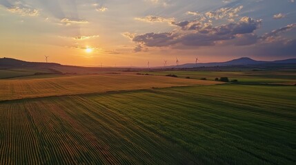 Fototapeta premium Sunrise over wind turbines in a sustainable energy landscape