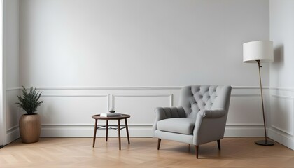 A gray tufted armchair in a minimalist living room with white walls and wooden floors.