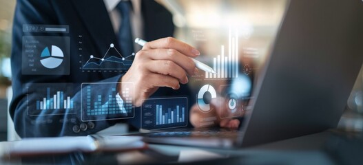 Fototapeta premium Data-Driven Decisions: A business professional analyzes glowing financial charts and graphs projected on a laptop, showcasing strategic planning in the corporate world. 