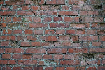 Old cracked red brick wall